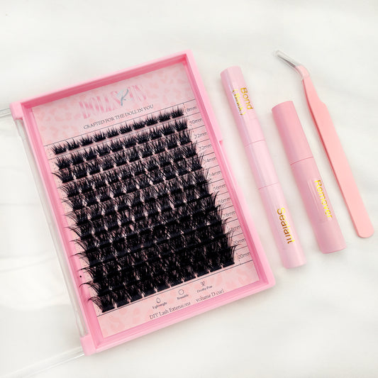False eyelashes set with applicator and tools on a white background